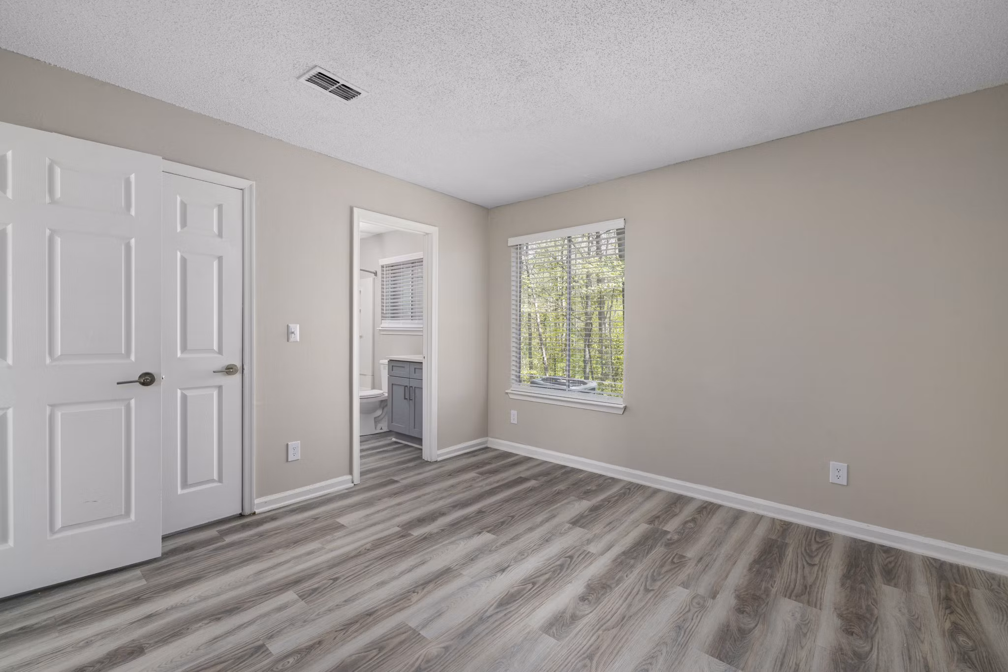 Spacious bedroom with natural light at Madison at Adams Farm Apartments