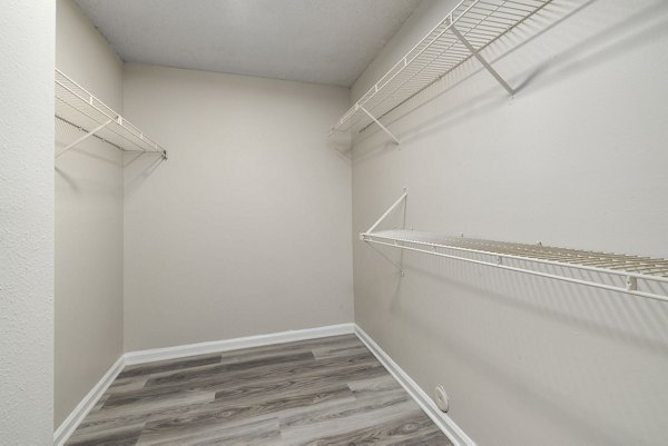 Organized walk-in closet with ample shelving in Madison at Adams Farm Apartments