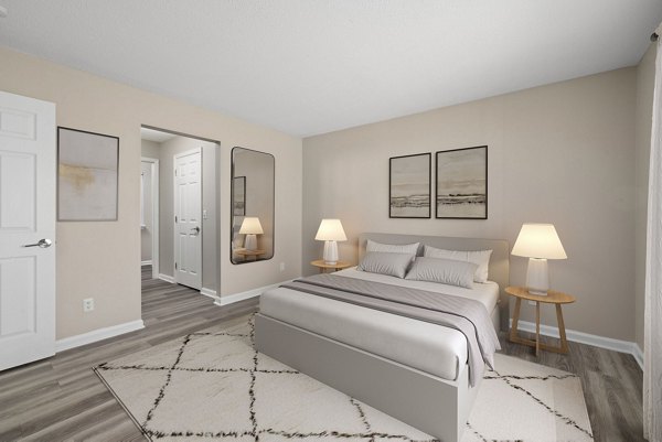 Cozy bedroom with a large window nook at Madison at Adams Farm Apartments