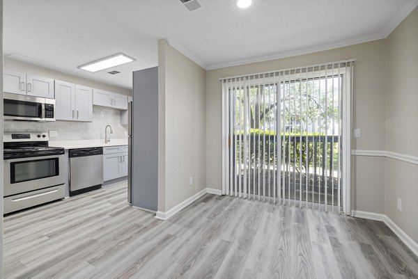 Dining area featuring modern decor and elegant lighting in Madison at Adams Farm Apartments