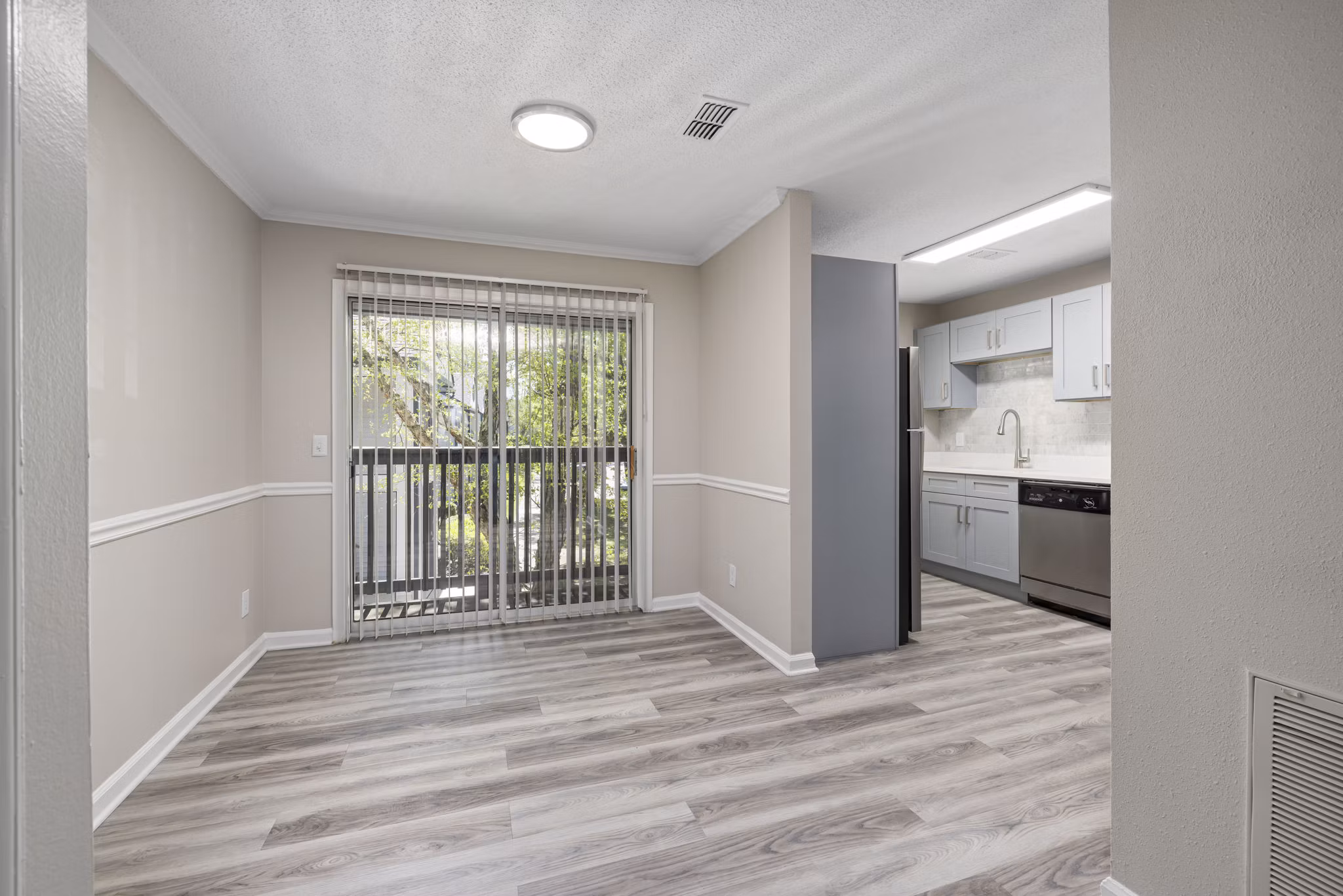 Dining area featuring elegant wooden dining set at Madison at Adams Farm Apartments, highlighting luxury living in a serene environment