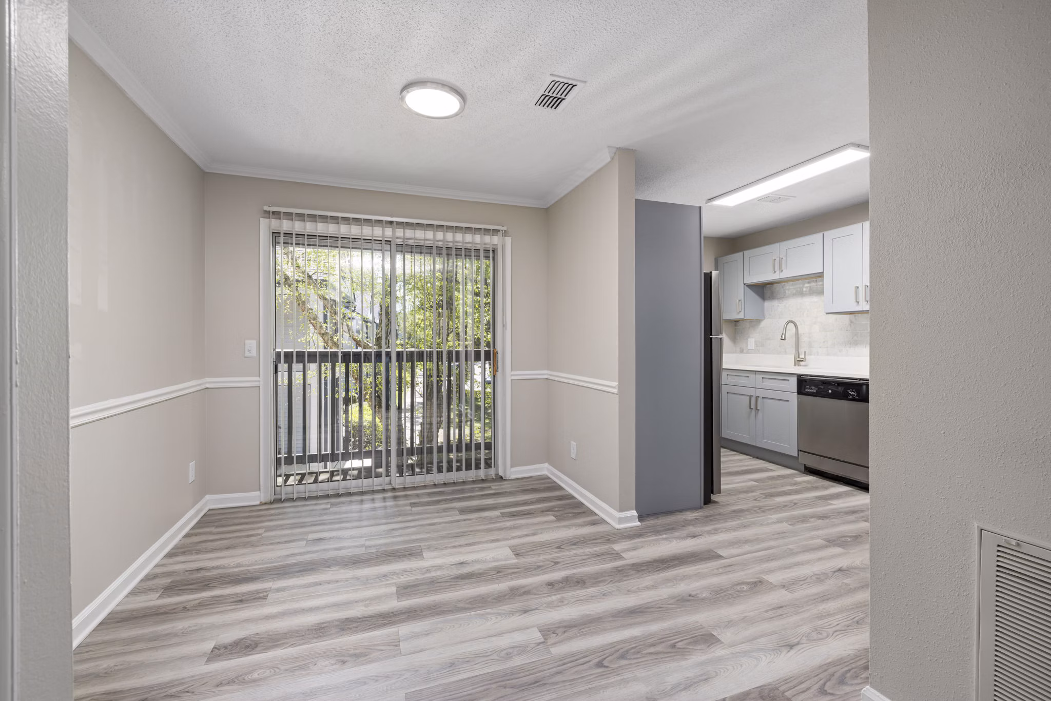 Dining area featuring elegant wooden dining set at Madison at Adams Farm Apartments, highlighting luxury living in a serene environment