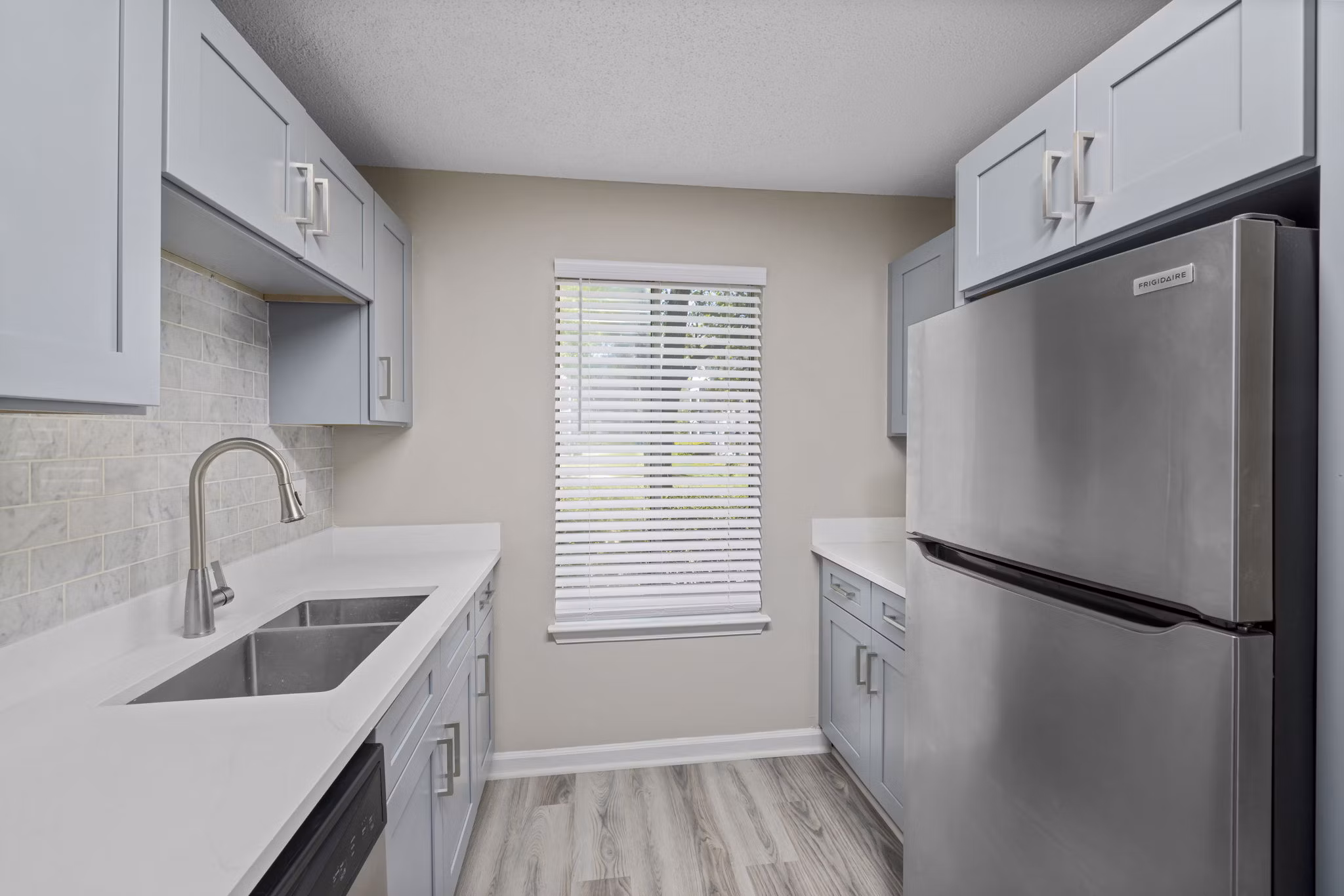 Modern kitchen with stainless steel appliances at Madison at Adams Farm Apartments