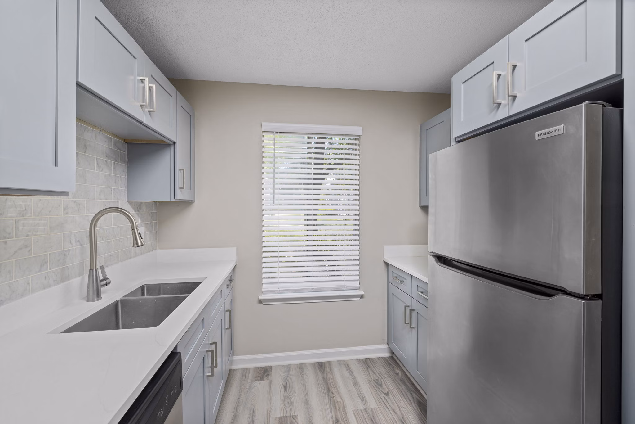 Modern kitchen with stainless steel appliances at Madison at Adams Farm Apartments