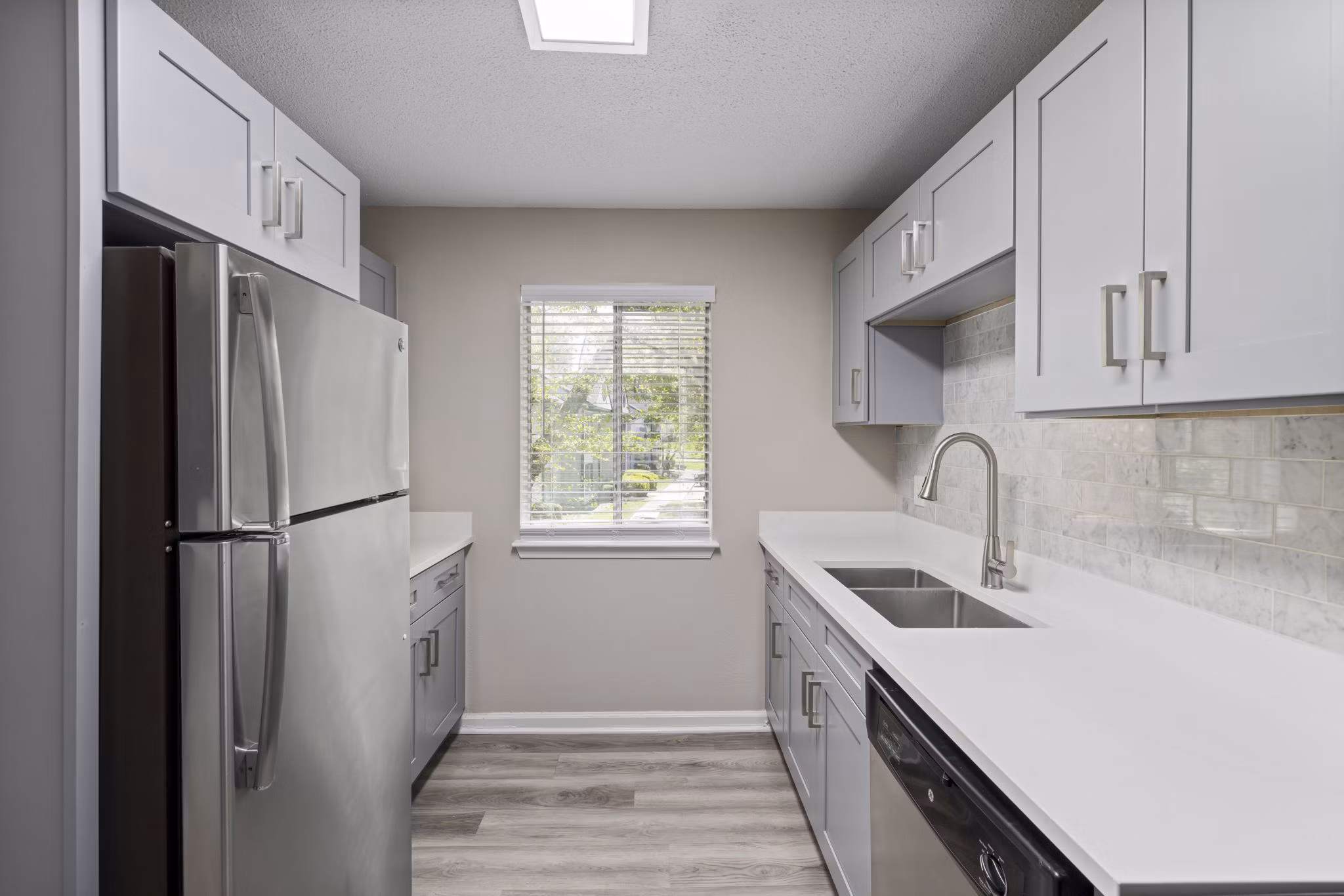 Modern kitchen with stainless steel appliances at Madison at Adams Farm Apartments