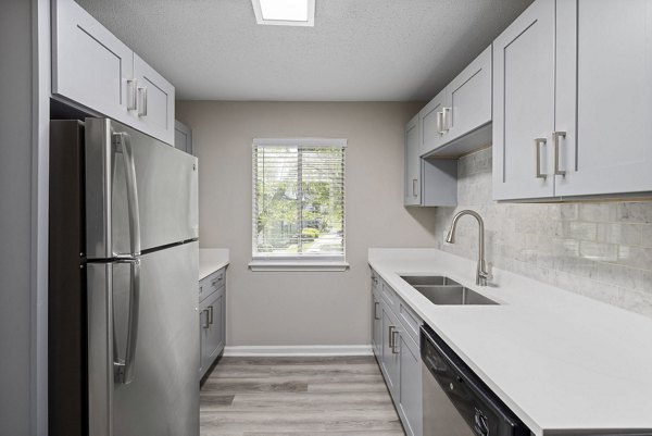 Modern kitchen with stainless steel appliances at Madison at Adams Farm Apartments