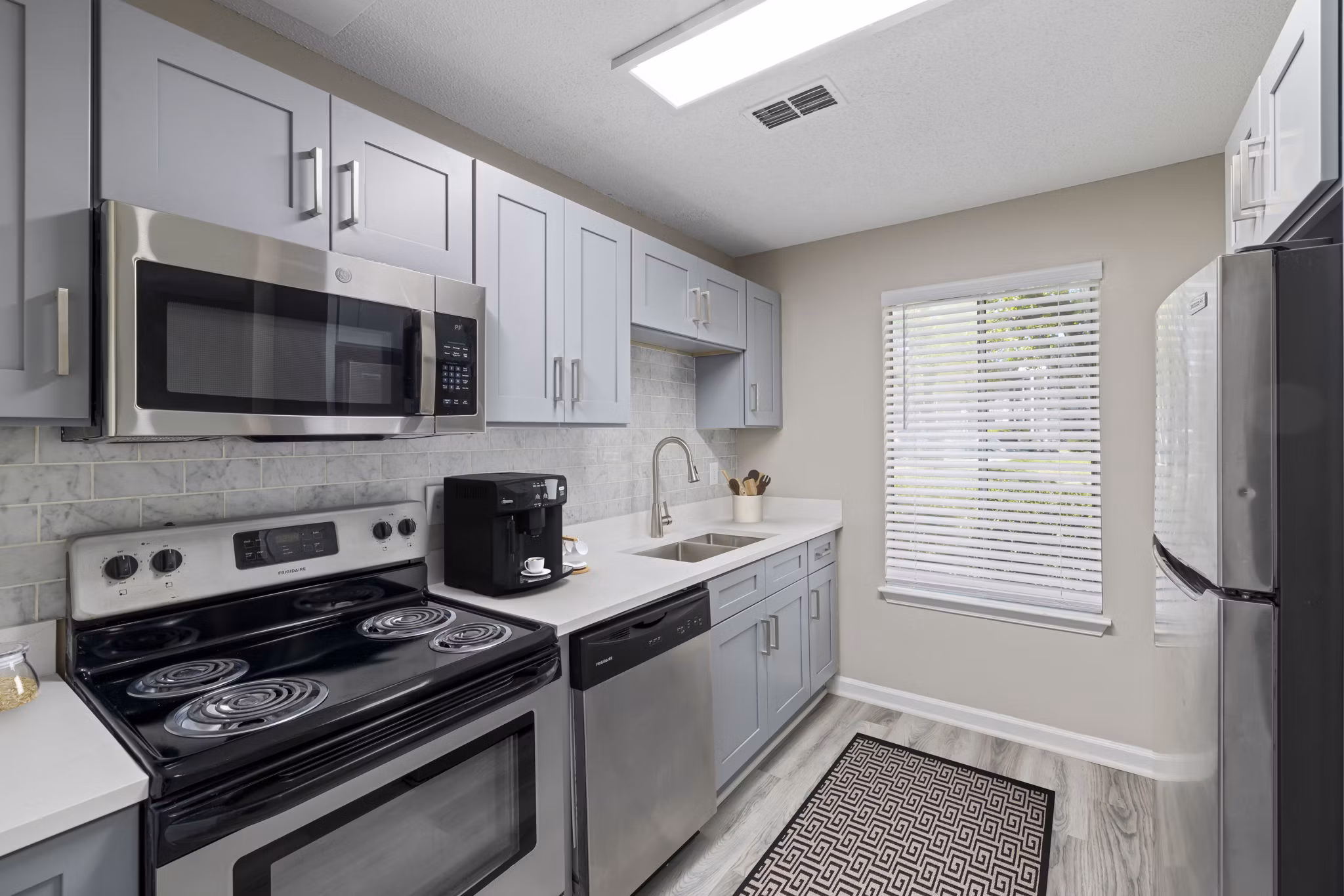 Modern kitchen with stainless steel appliances at Madison at Adams Farm Apartments