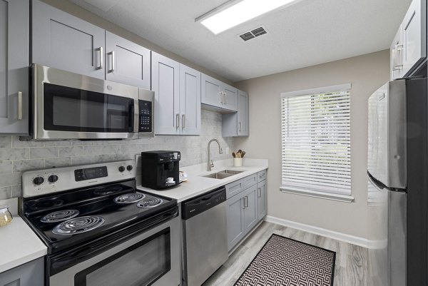 Modern kitchen with stainless steel appliances at Madison at Adams Farm Apartments