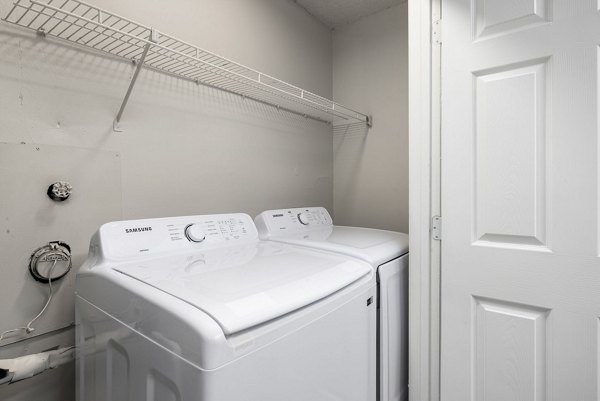 Laundry room with high-efficiency washer and dryer in Drexler Townhomes at Holbrook Farms