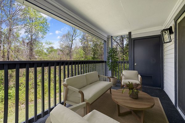 Outdoor patio with cozy seating and garden at Madison at Adams Farm Apartments