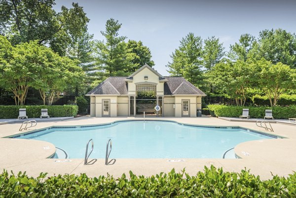 Outdoor pool with lounge chairs at Bay Court at Madison at Adams Farm Apartments, a luxury community offering relaxation and recreation