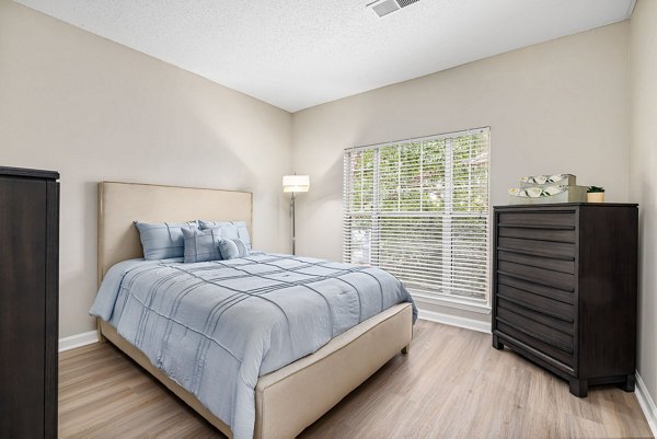 Bedroom with plush bedding and modern decor at Mariners Crossing Apartments
