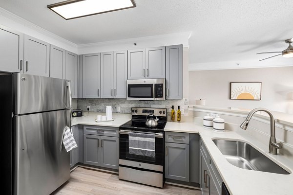 Kitchens with modern appliances and granite countertops in Mariners Crossing Apartments