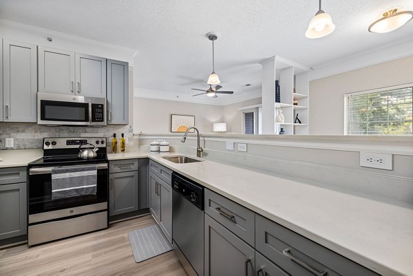 Modern kitchen with stainless steel appliances at Mariners Crossing Apartments