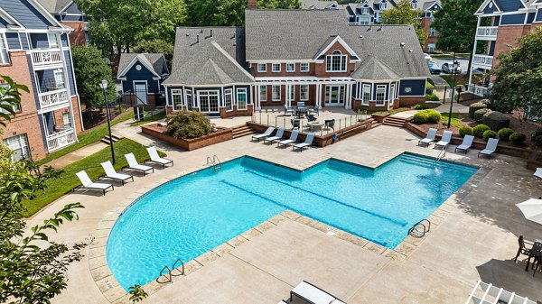 Relaxing pool at Mariners Crossing Apartments with lush landscaping and poolside seating