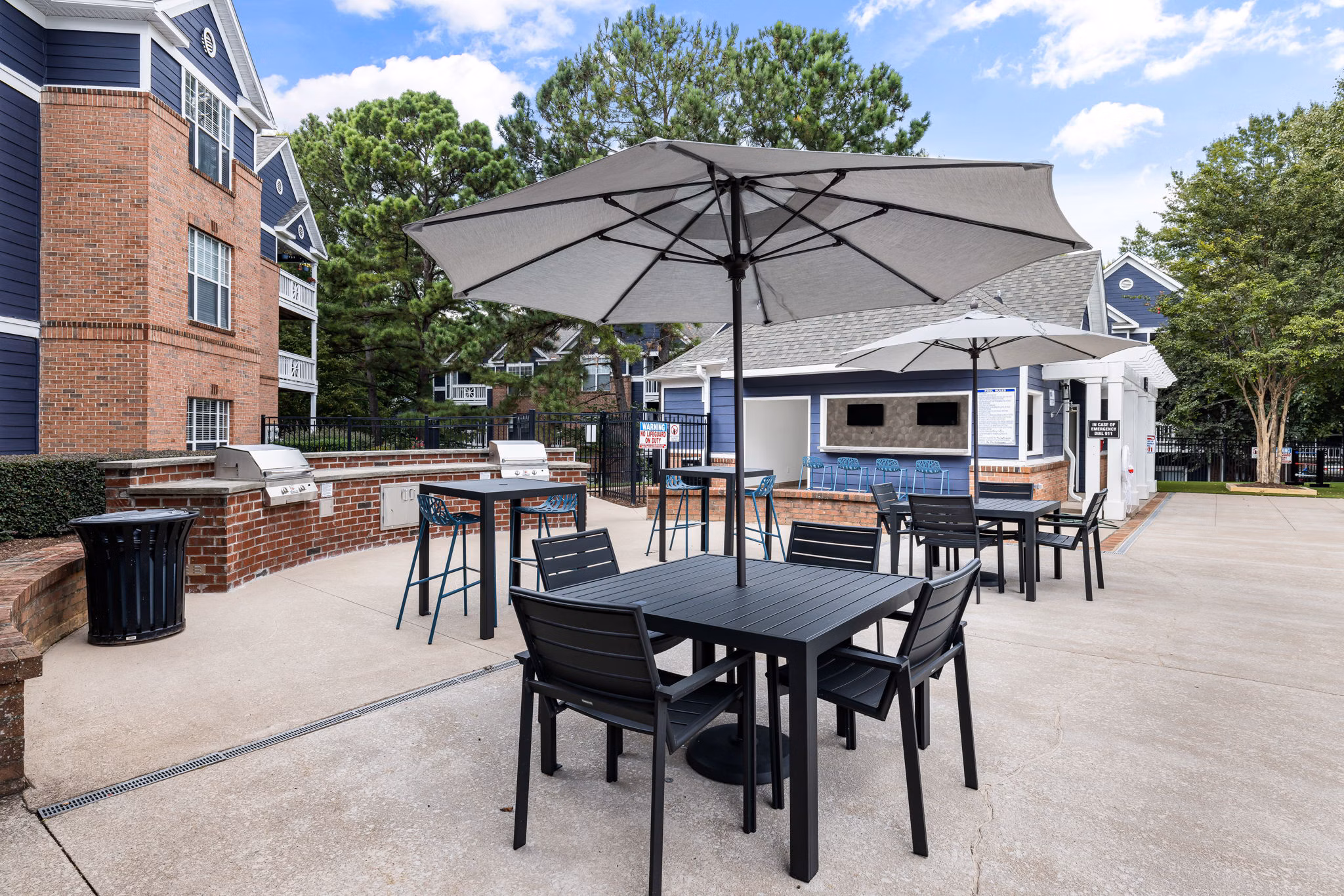 Outdoor grilling area with modern grills at Mariners Crossing Apartments