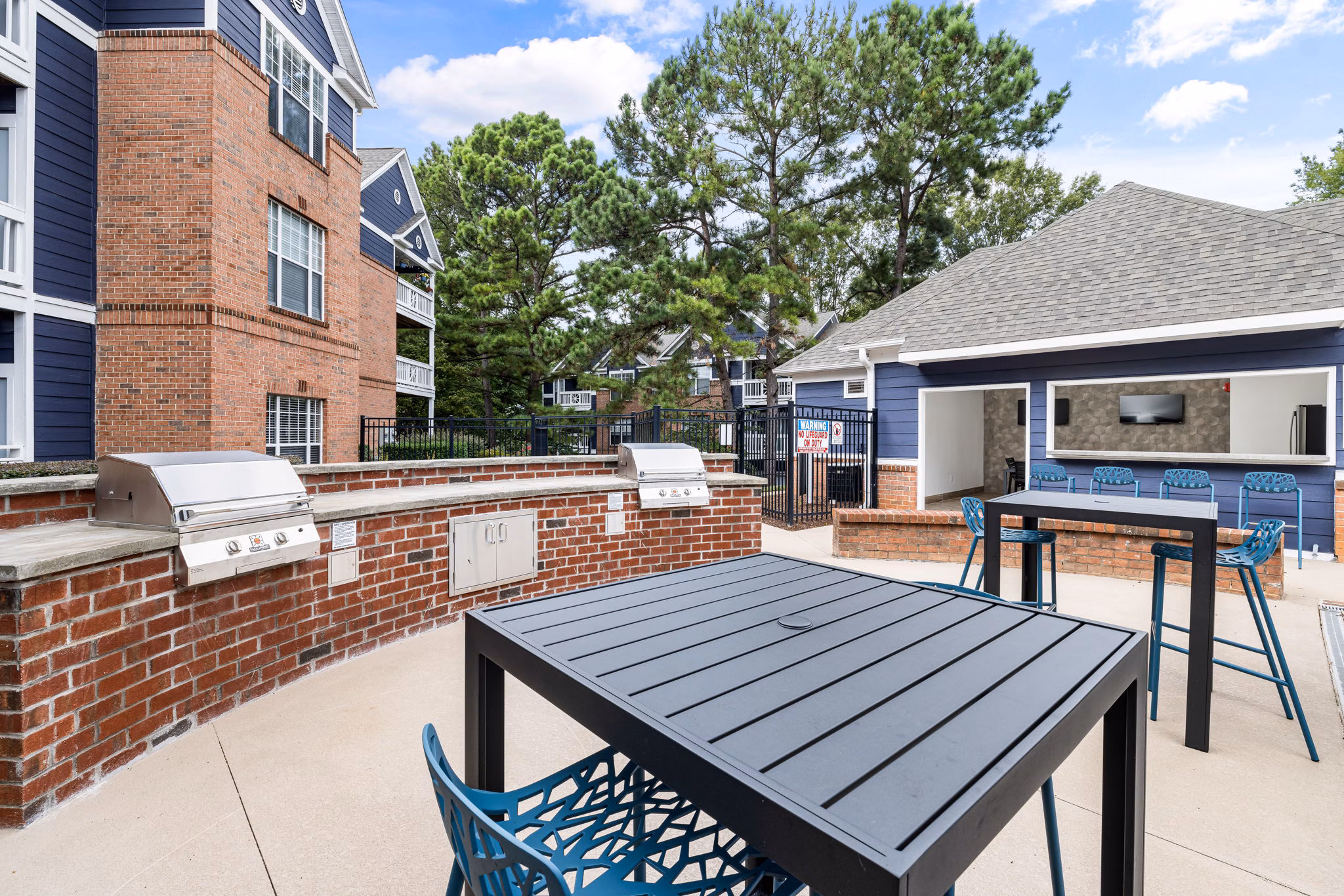 Outdoor grill area with modern equipment at Mariners Crossing Apartments, ideal for social gatherings and barbecues