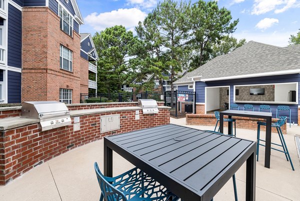 Outdoor grill area with modern equipment at Mariners Crossing Apartments, ideal for social gatherings and barbecues