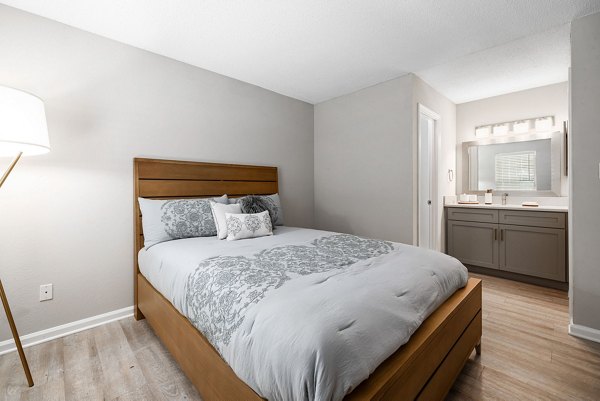 Cozy bedroom with modern furnishings at View at Lake Lynn Apartments, offering luxury and comfort in a serene Raleigh setting