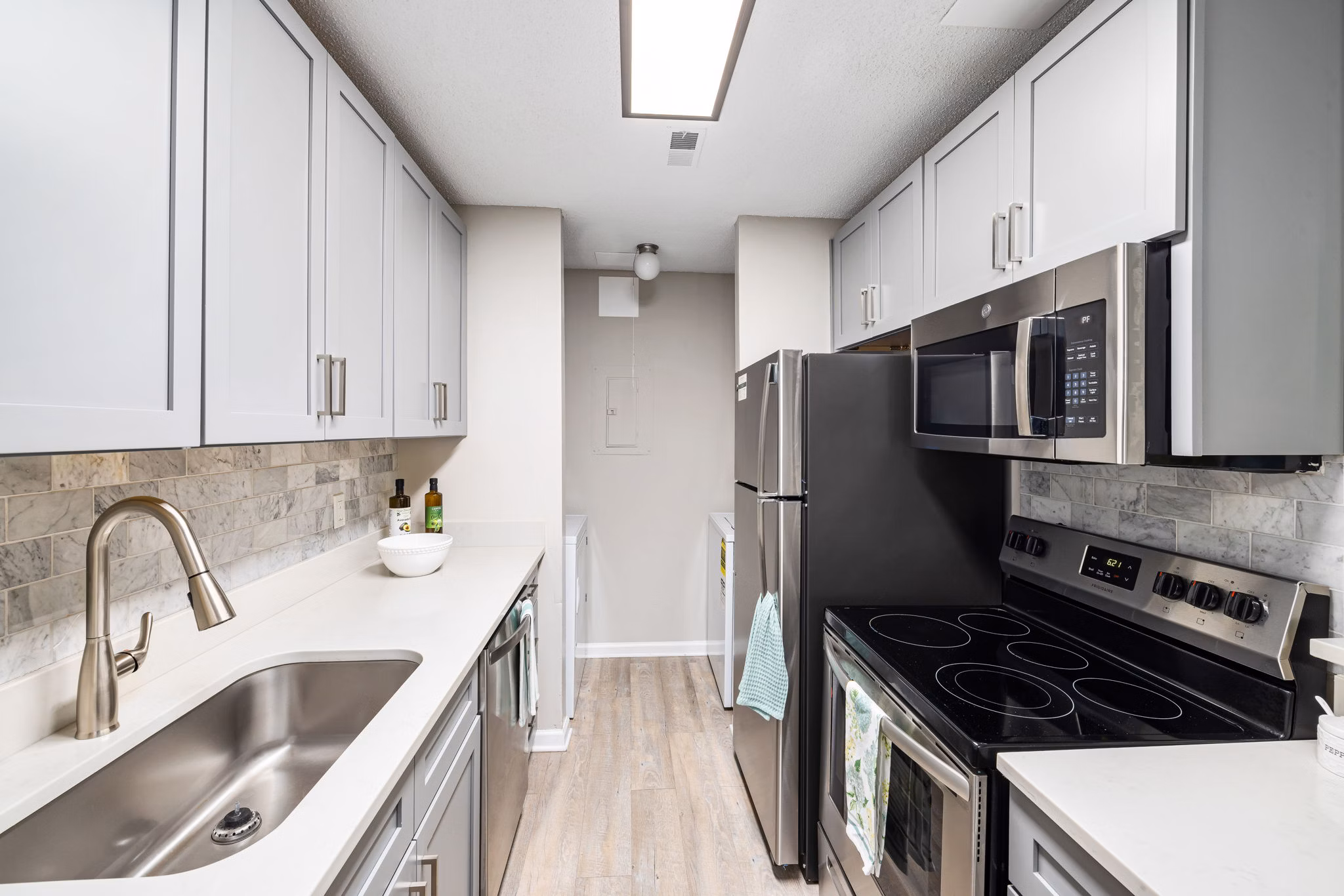 Modern kitchen with stainless steel appliances and granite countertops at View at Lake Lynn Apartments, ideal for Greystar luxury living