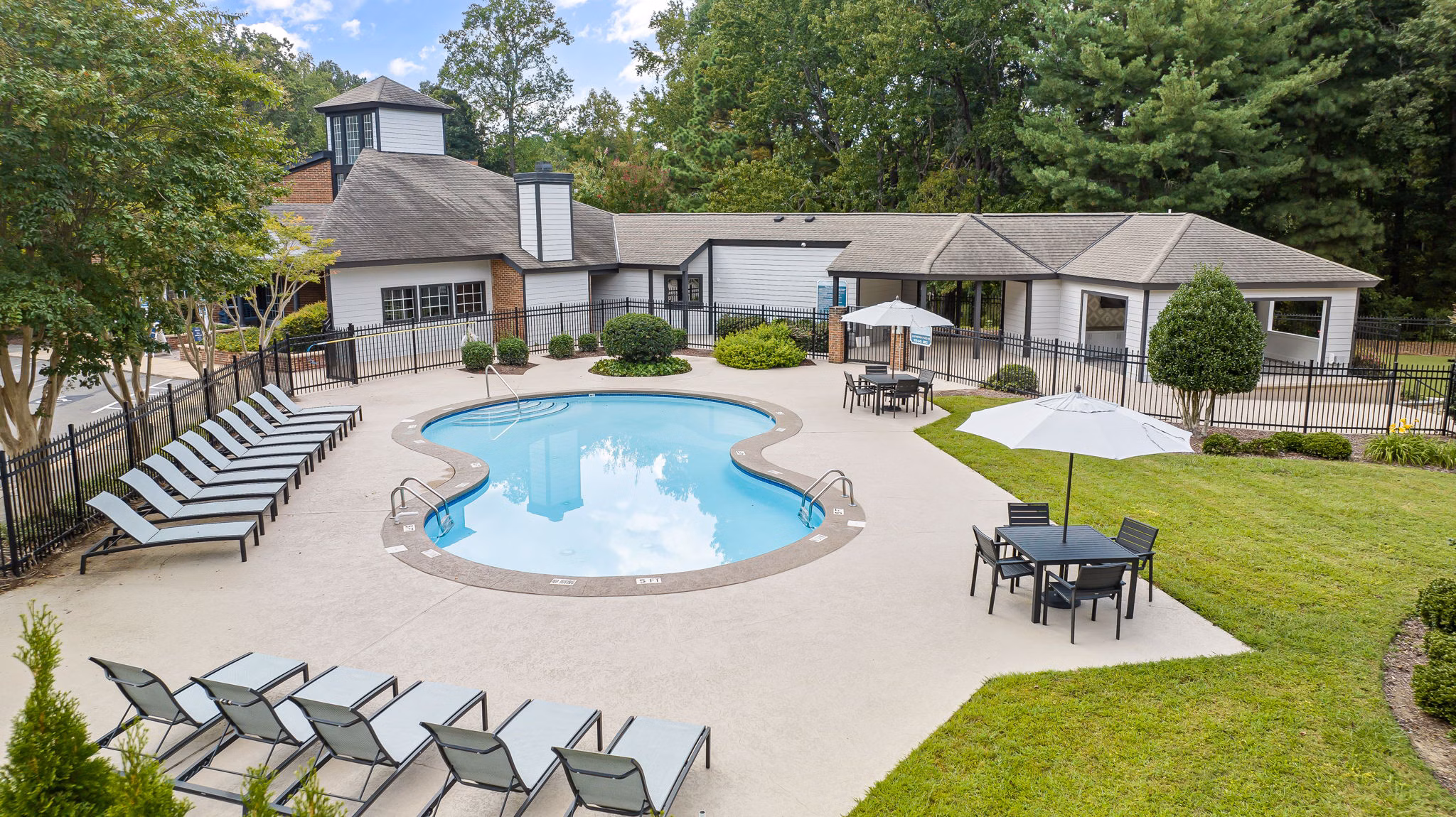 Resort-style pool with lounge seating at View at Lake Lynn Apartments