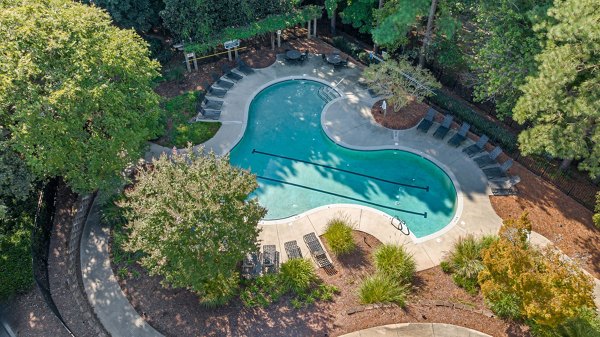 Scenic outdoor pool area at View at Lake Lynn Apartments featuring a spacious sundeck and lush landscaping