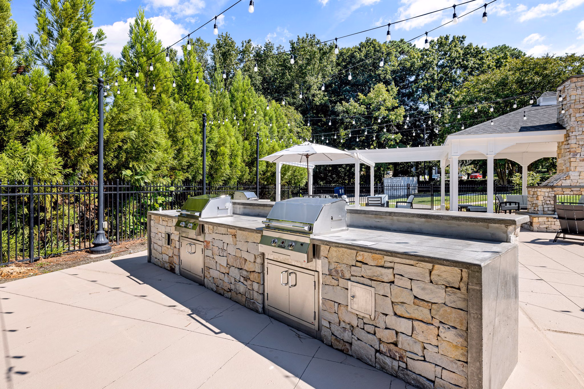 Grill area with modern outdoor seating at View at Lake Lynn Apartments