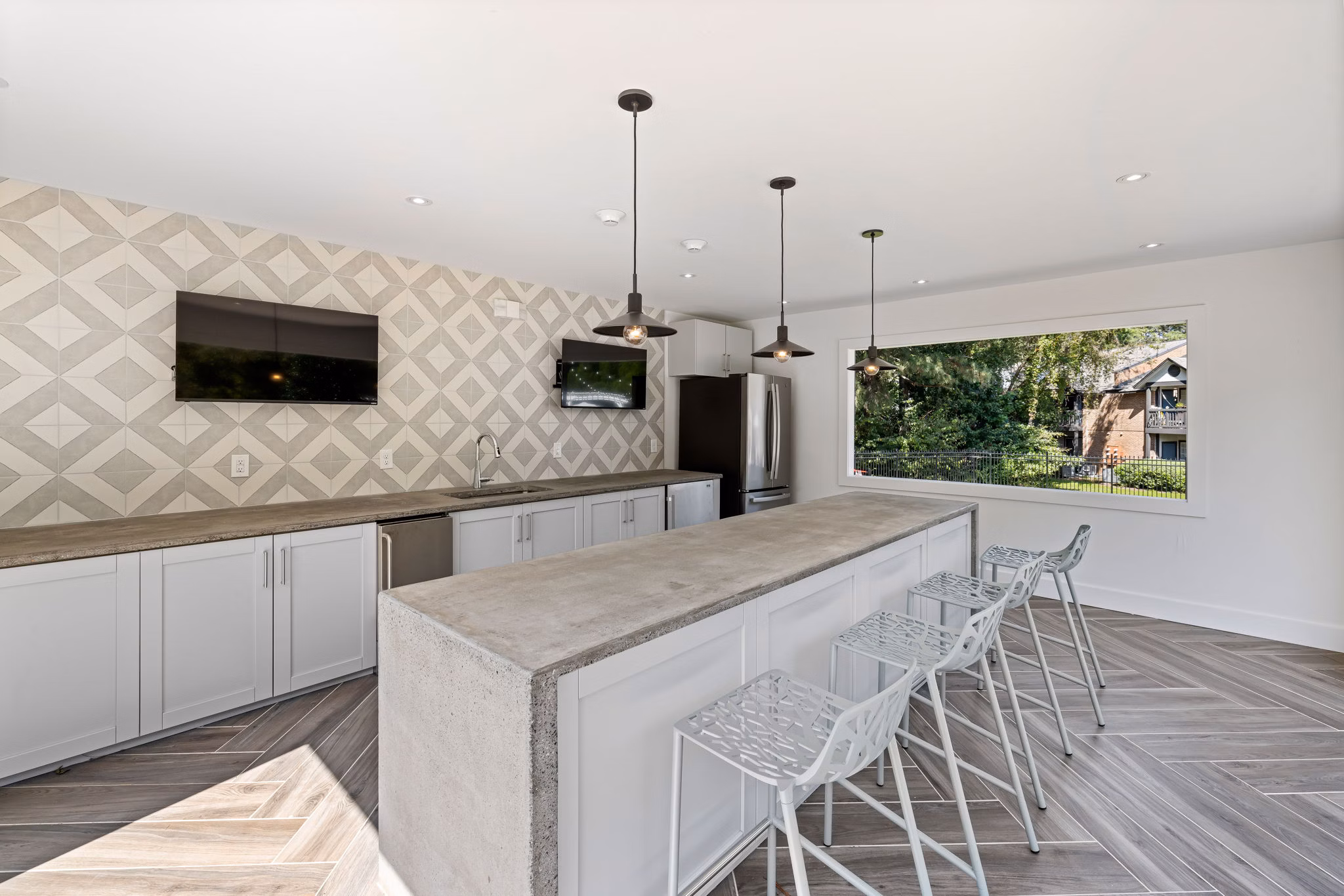 View at Lake Lynn Apartments: Modern patio space with seating and greenery, ideal for relaxation and socializing in a luxury setting