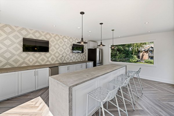 View at Lake Lynn Apartments: Modern patio space with seating and greenery, ideal for relaxation and socializing in a luxury setting