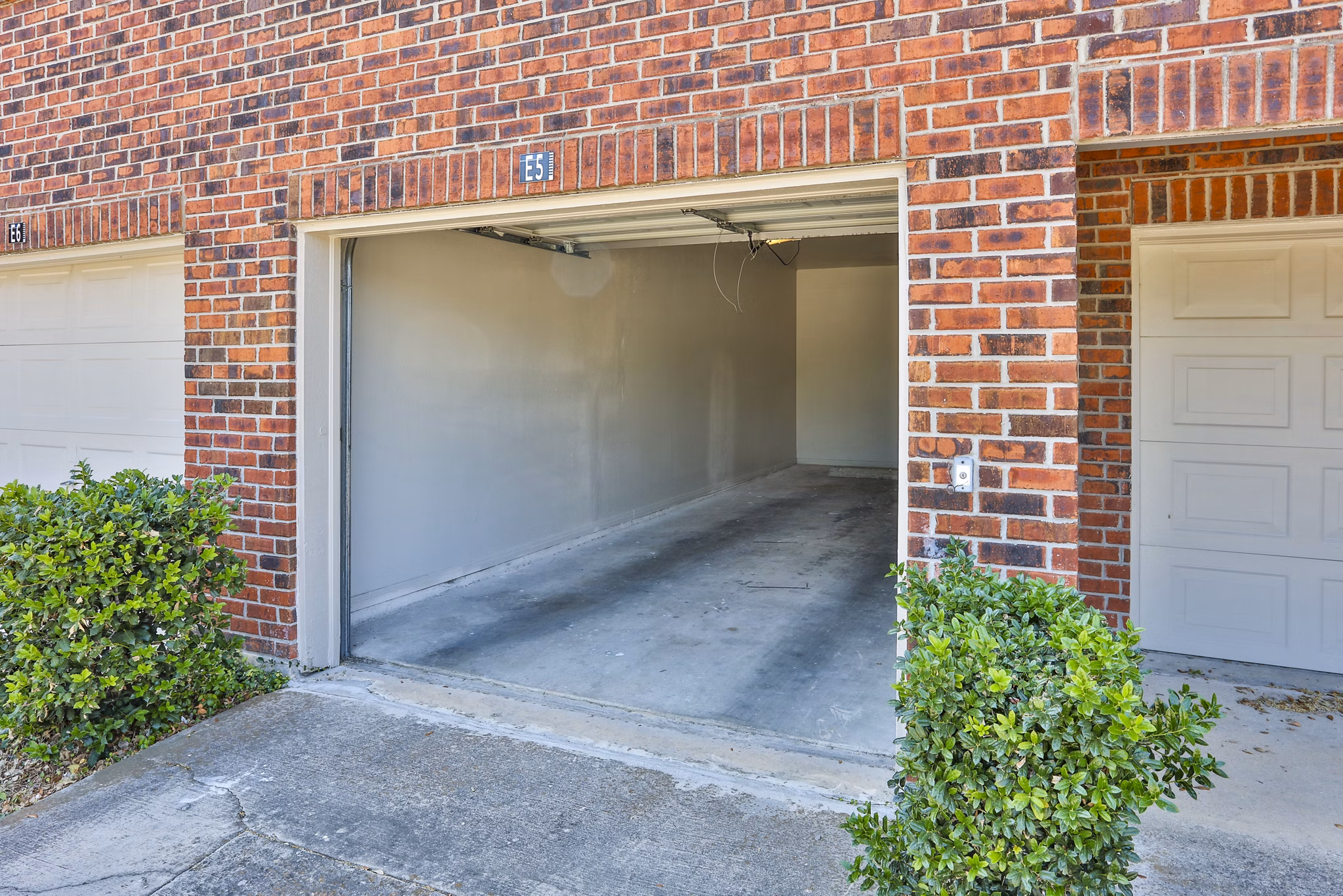 Secure covered parking garage at The Quarry Alamo Heights Apartments, ideal for residents seeking protected vehicle storage solutions