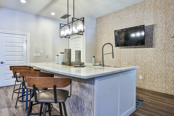 Clubhouse lobby with modern decor and seating at The Quarry Alamo Heights Apartments