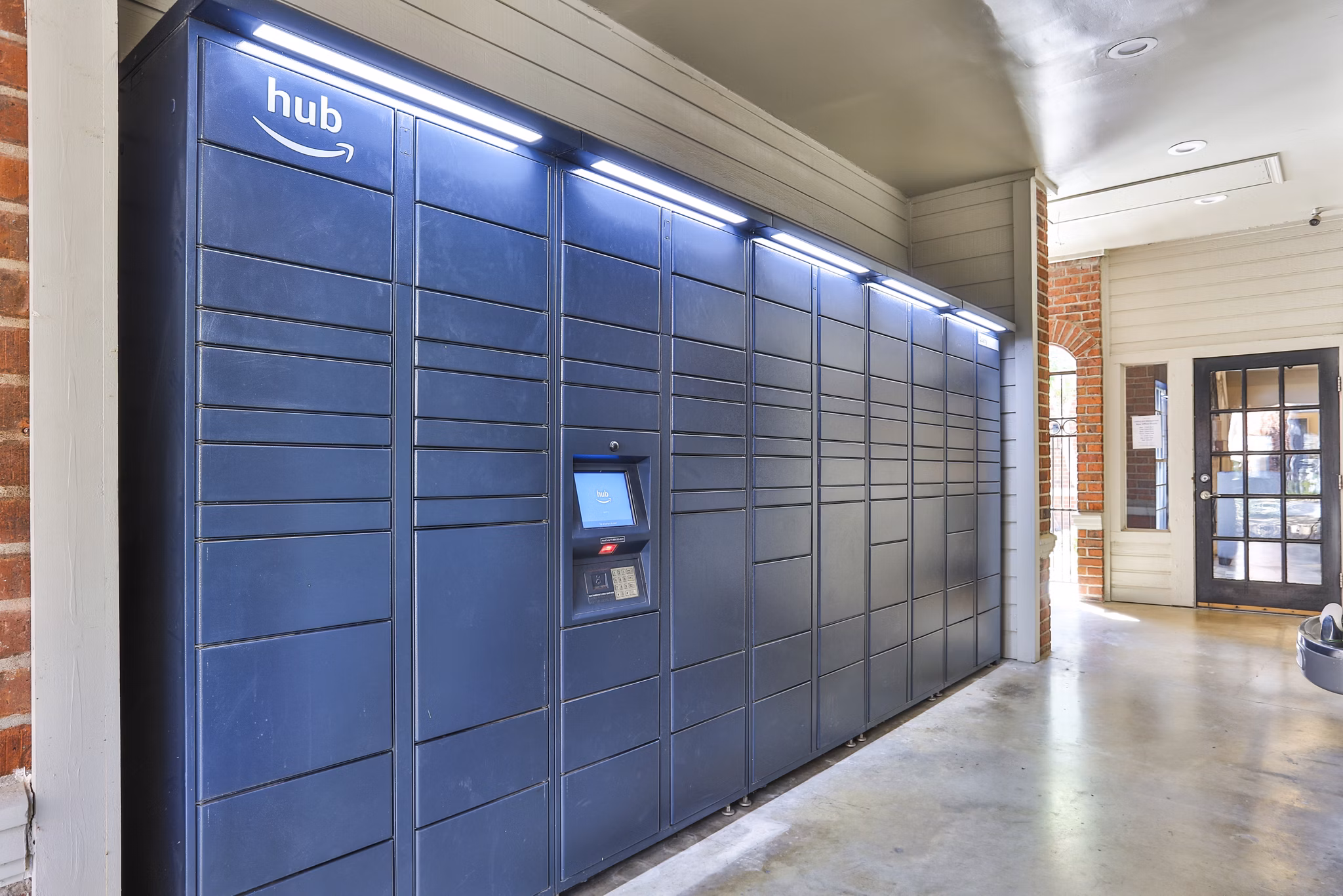 Clubhouse with modern parcel lockers at The Quarry Alamo Heights Apartments offering luxury living