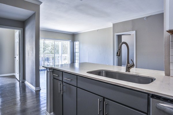 Spacious kitchen with modern appliances and marble countertops in The Quarry Alamo Heights Apartments