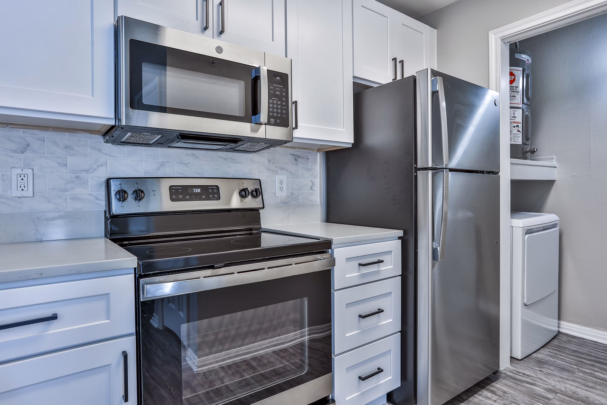 Modern kitchen featuring stainless steel appliances at The Quarry Alamo Heights Apartments in Alamo Heights