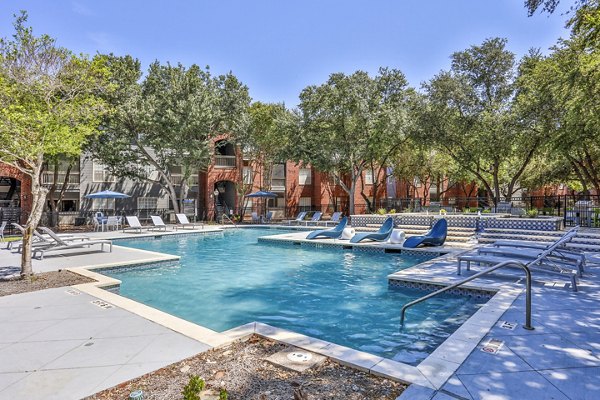 Resort-style pool with lounge chairs at The Quarry Alamo Heights Apartments