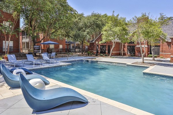 Luxurious outdoor pool area at The Quarry Alamo Heights Apartments, perfect for relaxing and socializing in a peaceful setting