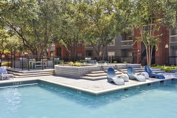 Resort-style pool with deck chairs at The Quarry Alamo Heights Apartments