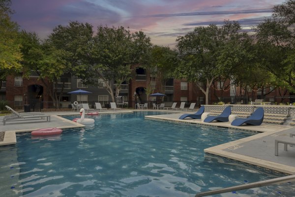 Luxury pool with lounge chairs at The Quarry Alamo Heights Apartments