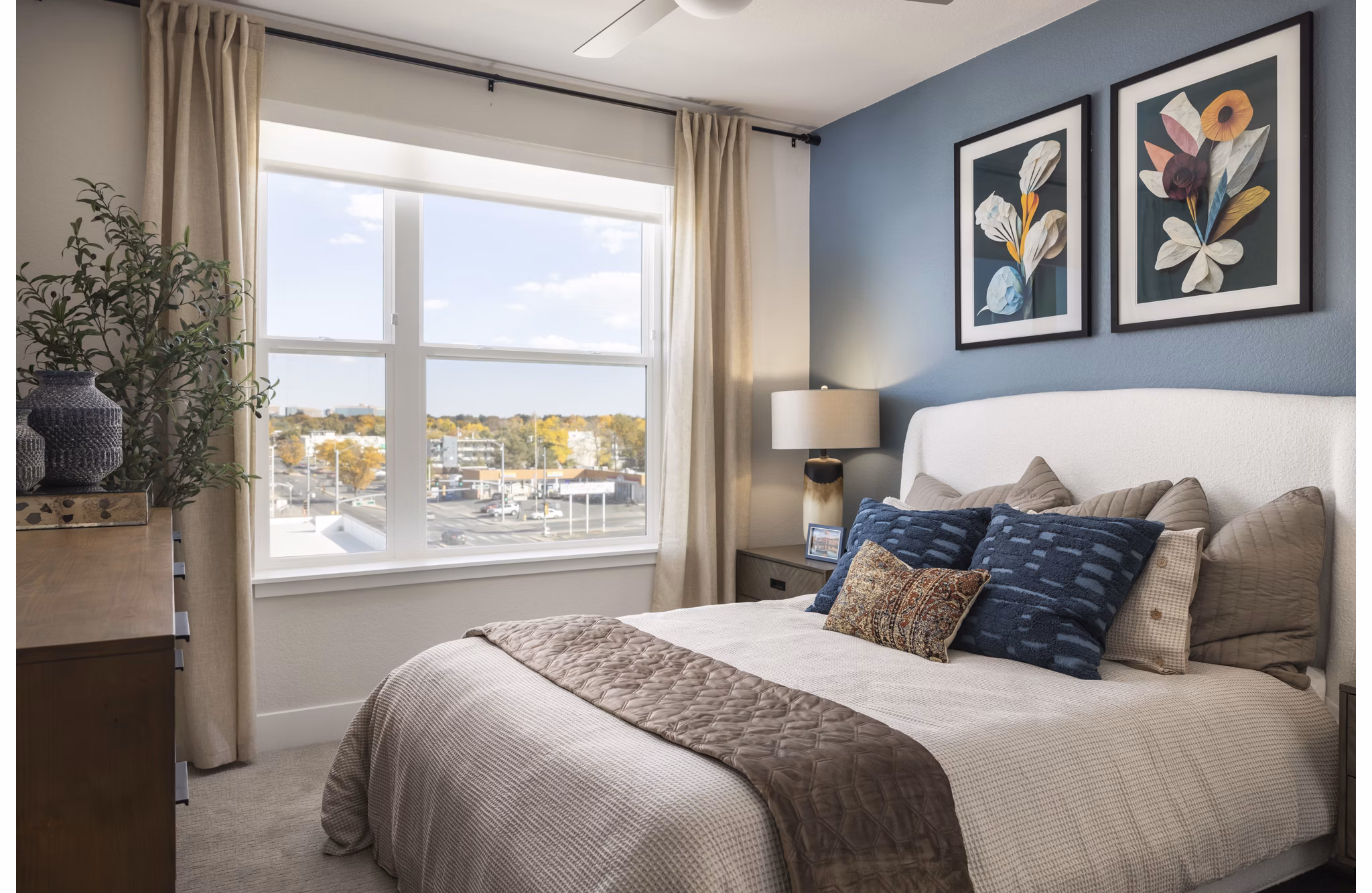 Cozy bedroom with modern decor at Alexan Montview Plaza Apartments in Denver