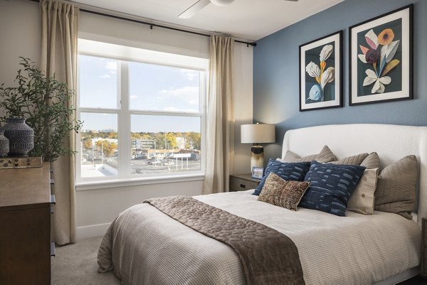 Cozy bedroom with modern decor at Alexan Montview Plaza Apartments in Denver