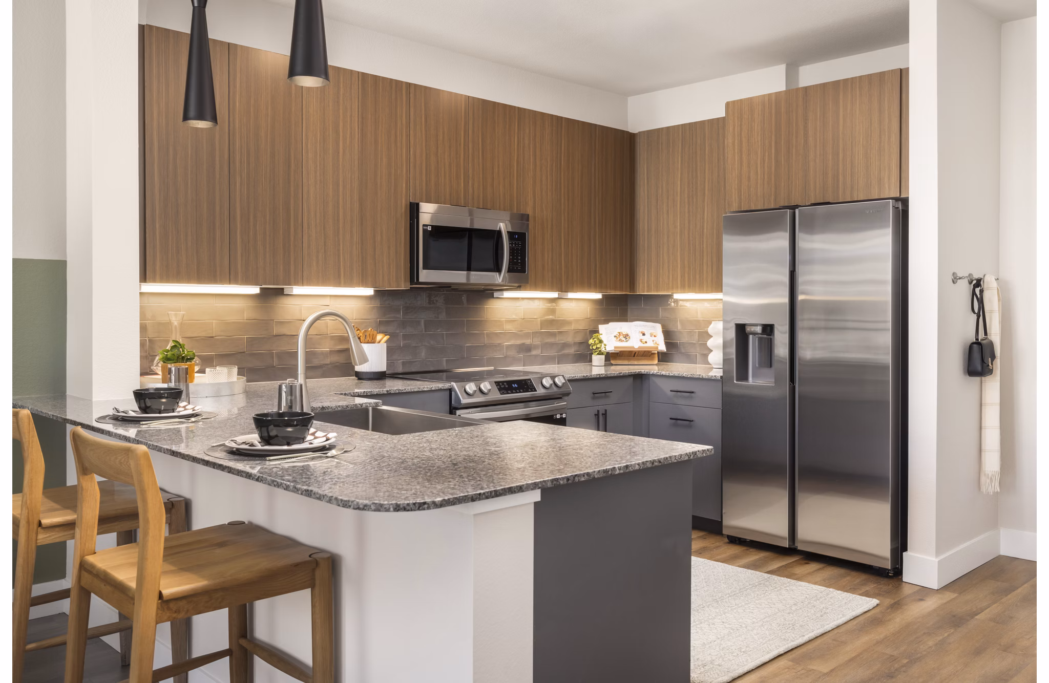 Modern kitchen with stainless steel appliances in Alexan Montview Plaza Apartments