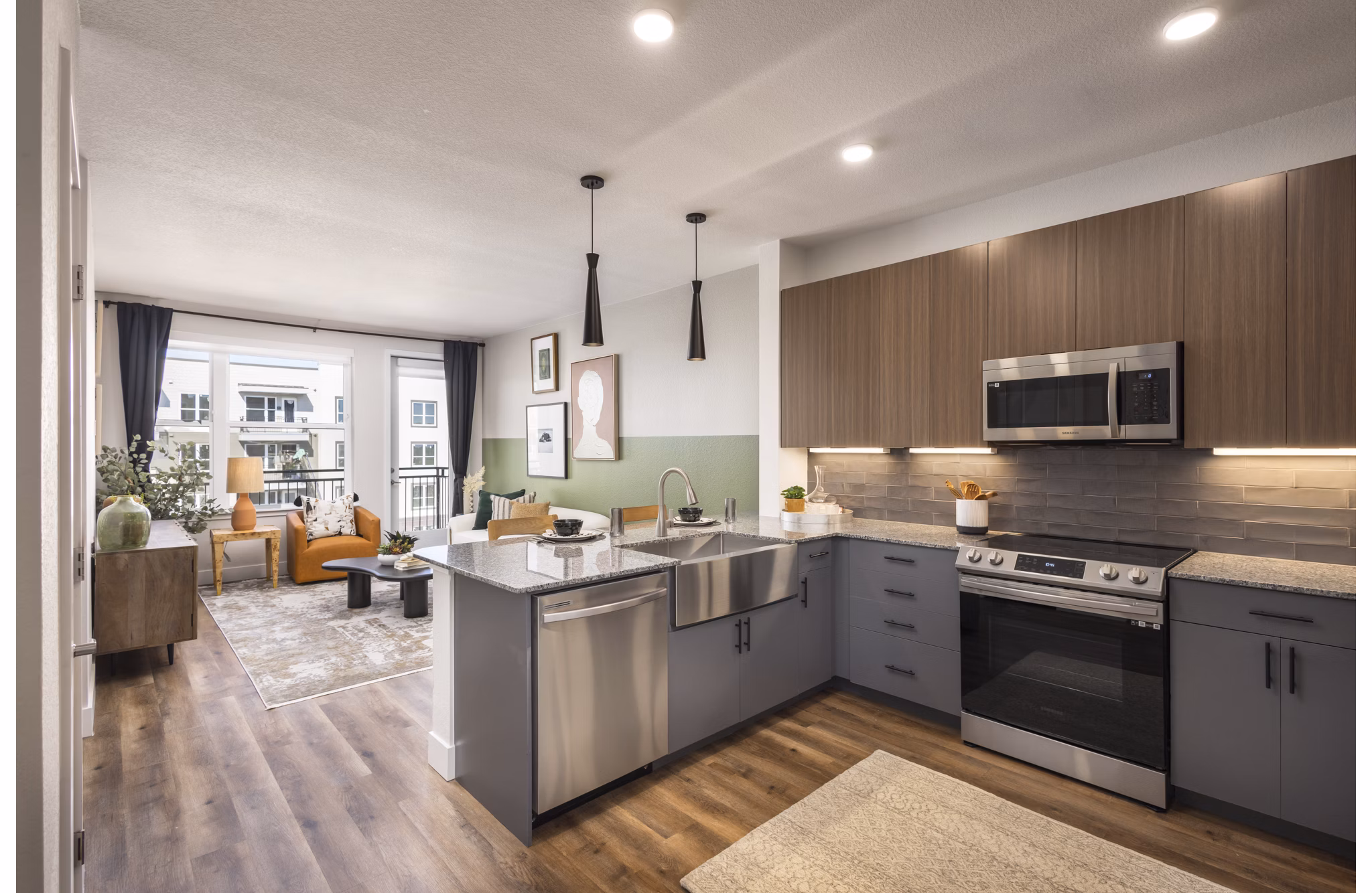Modern kitchen featuring sleek cabinetry and stainless steel appliances at Alexan Montview Plaza Apartments