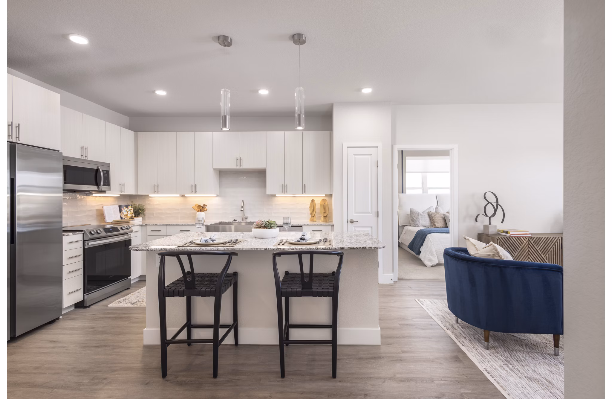 Modern kitchen with stainless steel appliances at Alexan Montview Plaza Apartments