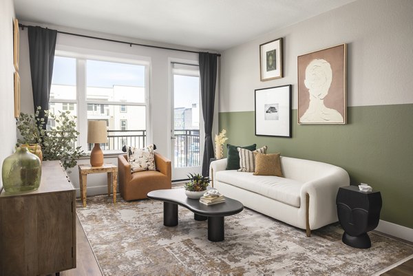 Bright, open-concept living room with modern furnishings at Alexan Montview Plaza Apartments, offering luxurious city living