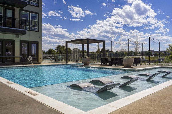 Luxurious pool with sun loungers at Alexan Montview Plaza Apartments, ideal for relaxation and leisure activities