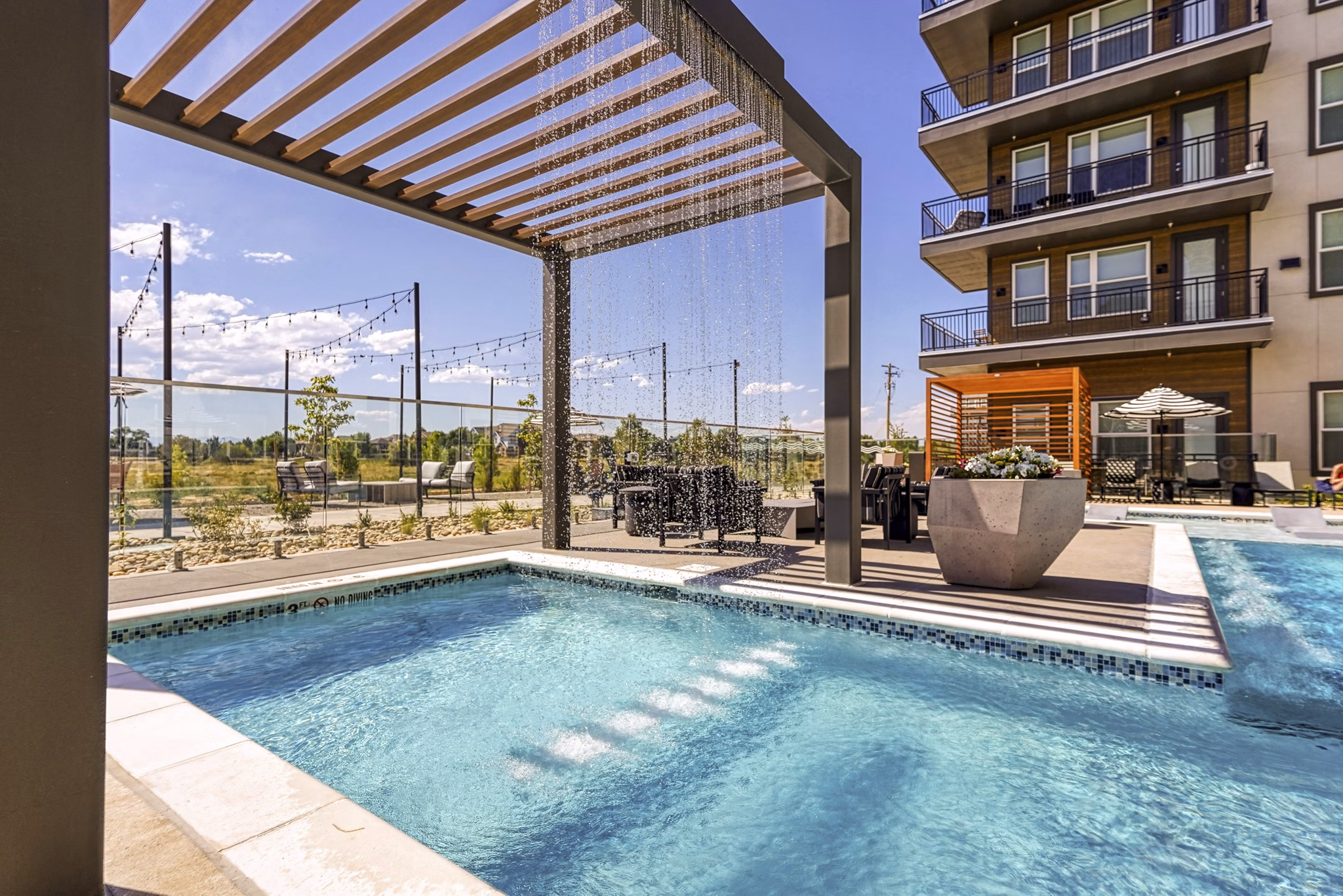 Rooftop pool with city views at Alexan Montview Plaza Apartments