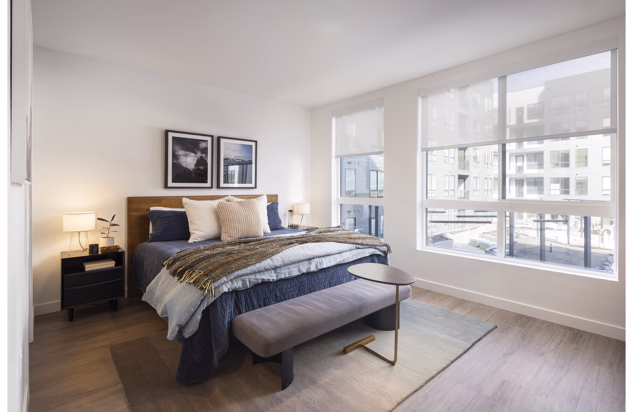 Cozy modern bedroom with plush bedding in Forge Apartments, offering luxury living in the heart of the city