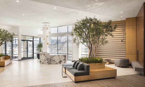 Clubhouse with modern seating and contemporary lighting at Forge Apartments, a Greystar luxury apartment community