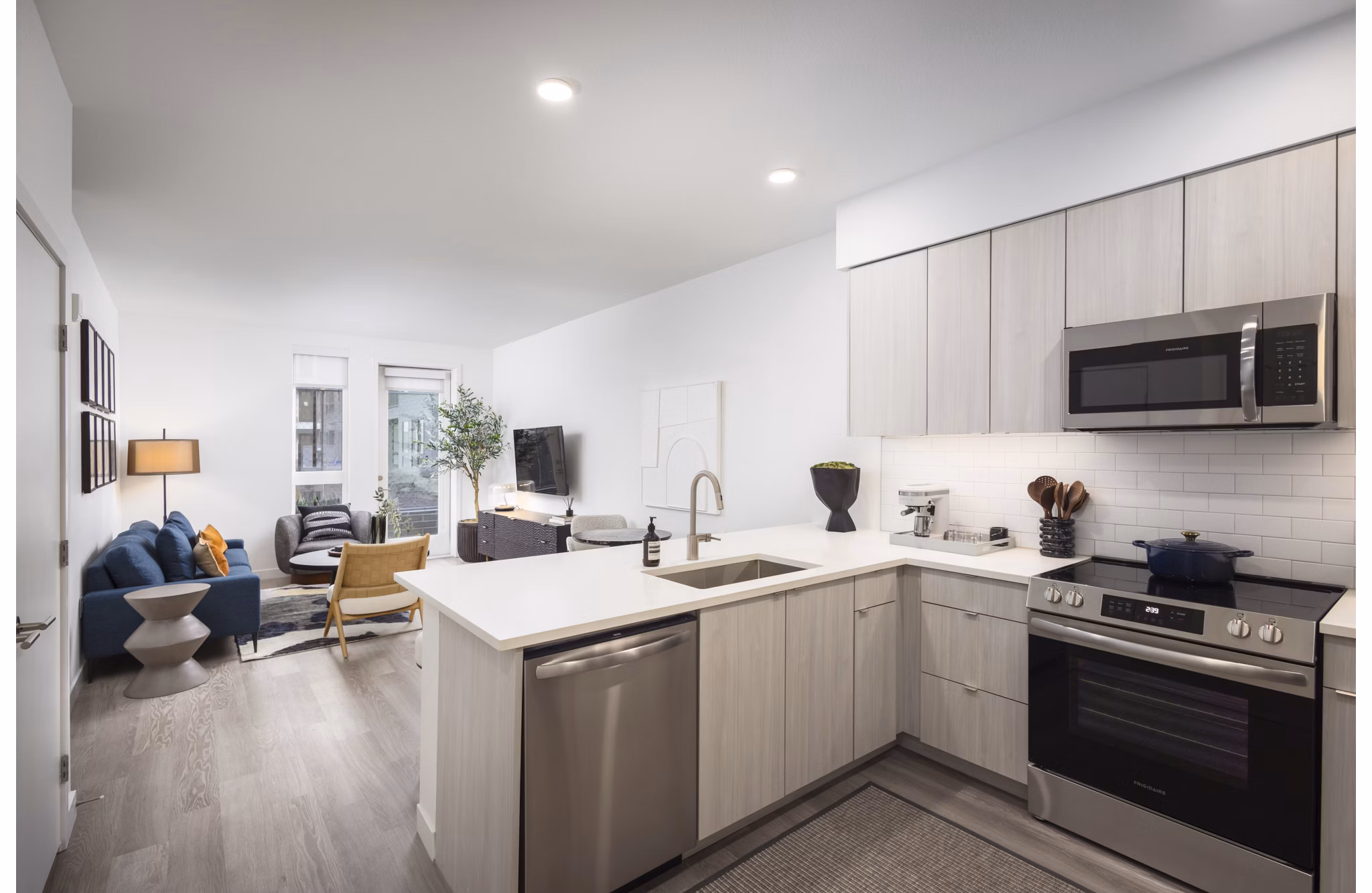 Modern kitchen with stainless steel appliances at Forge Apartments in Denver, CO.