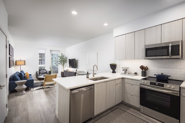 Modern kitchen with stainless steel appliances at Forge Apartments in Denver, CO.